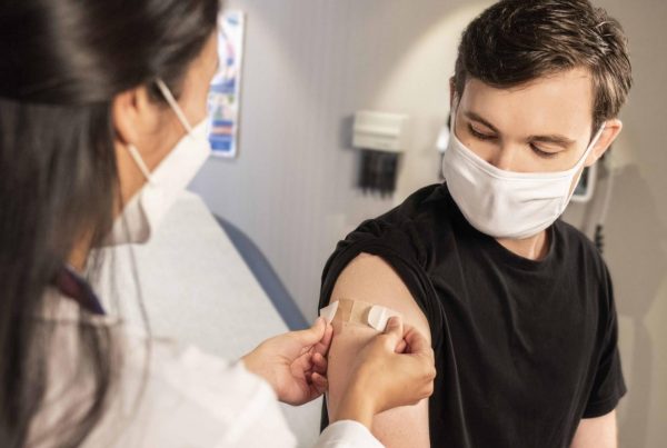 masked person getting a vaccine