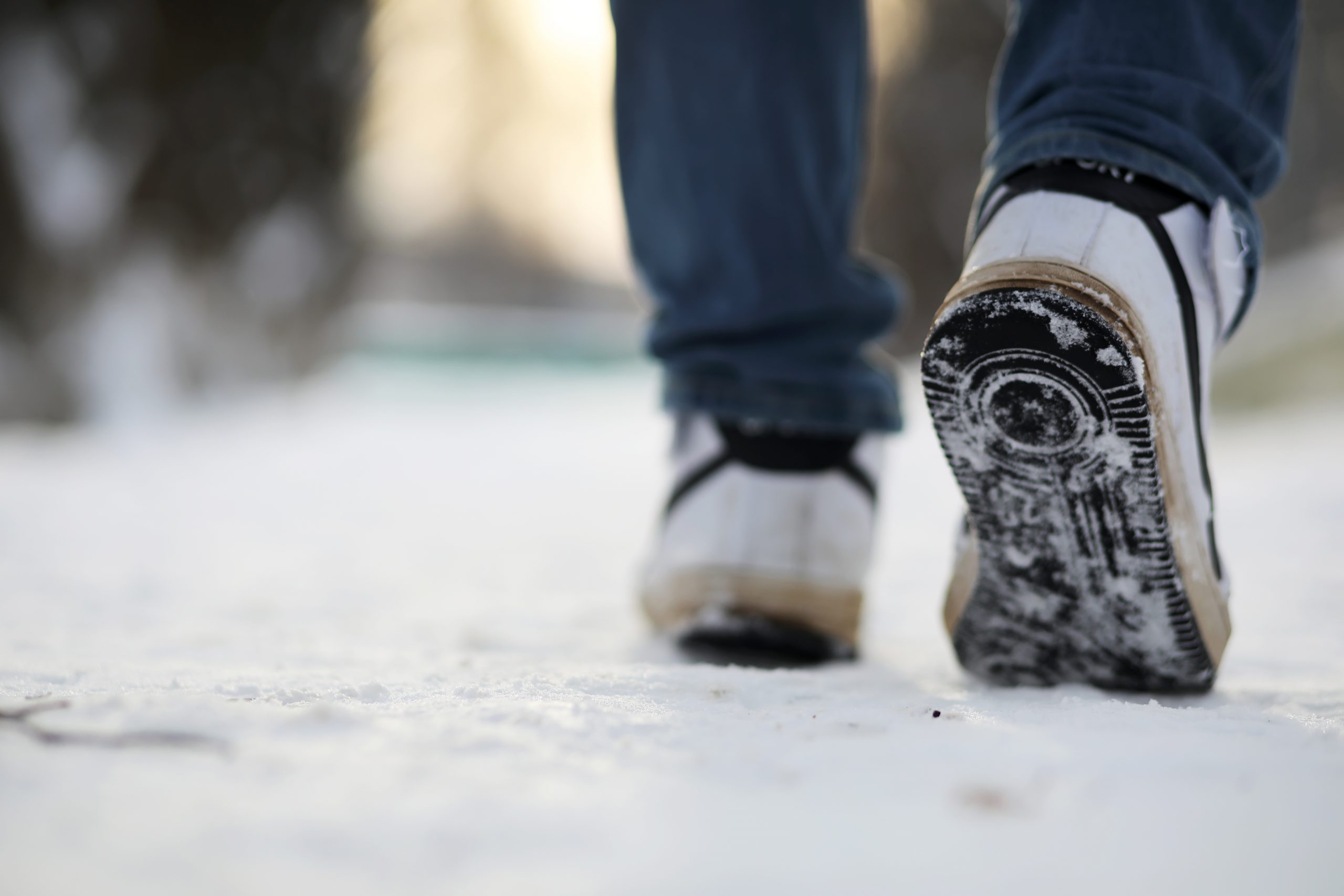close up of shoes walking in snow