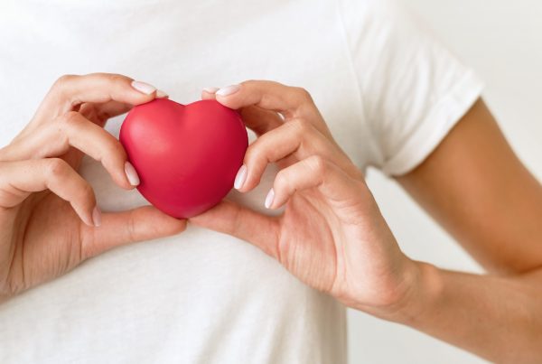 close up of hands holding a toy heart