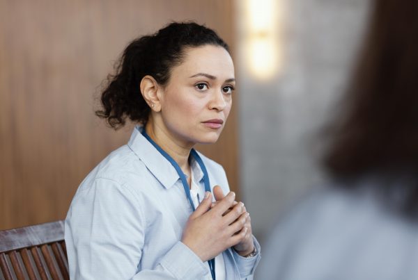 A woman looks anxiously at another person