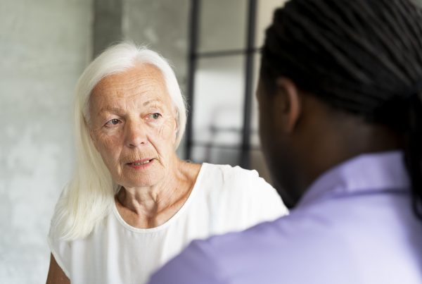 elderly woman looking suspiciously at another person