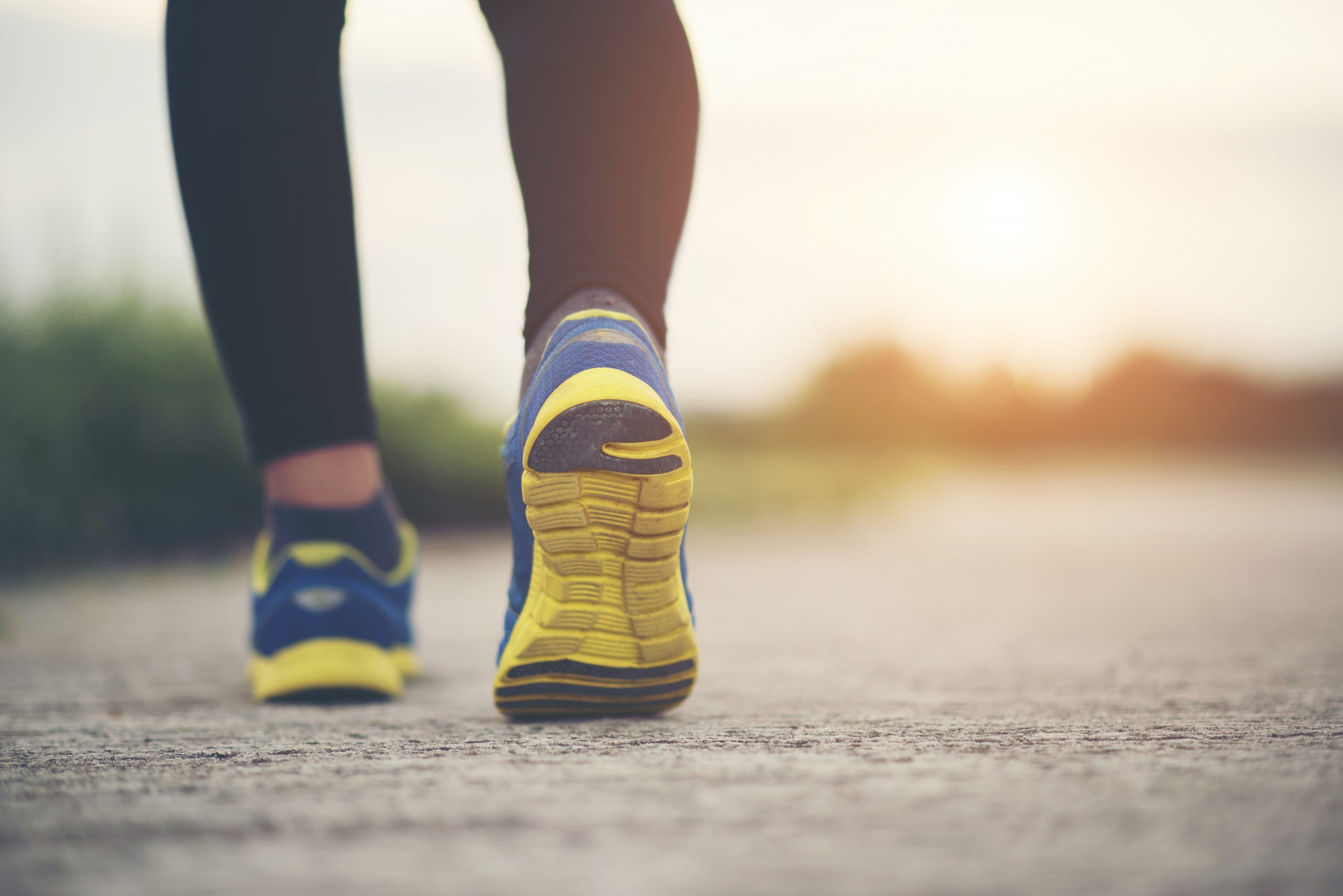 close up of person walking in running shoes