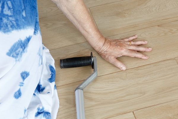 person on the floor with a cane