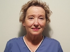 headshot of person wearing scrubs