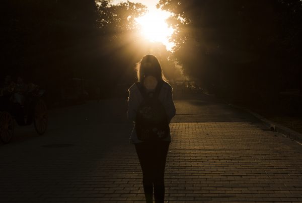 silouhette of a woman walking at sunset