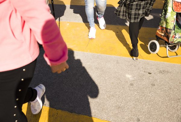 feet and legs in a crosswalk