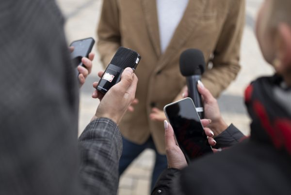 close up of people holding microphones