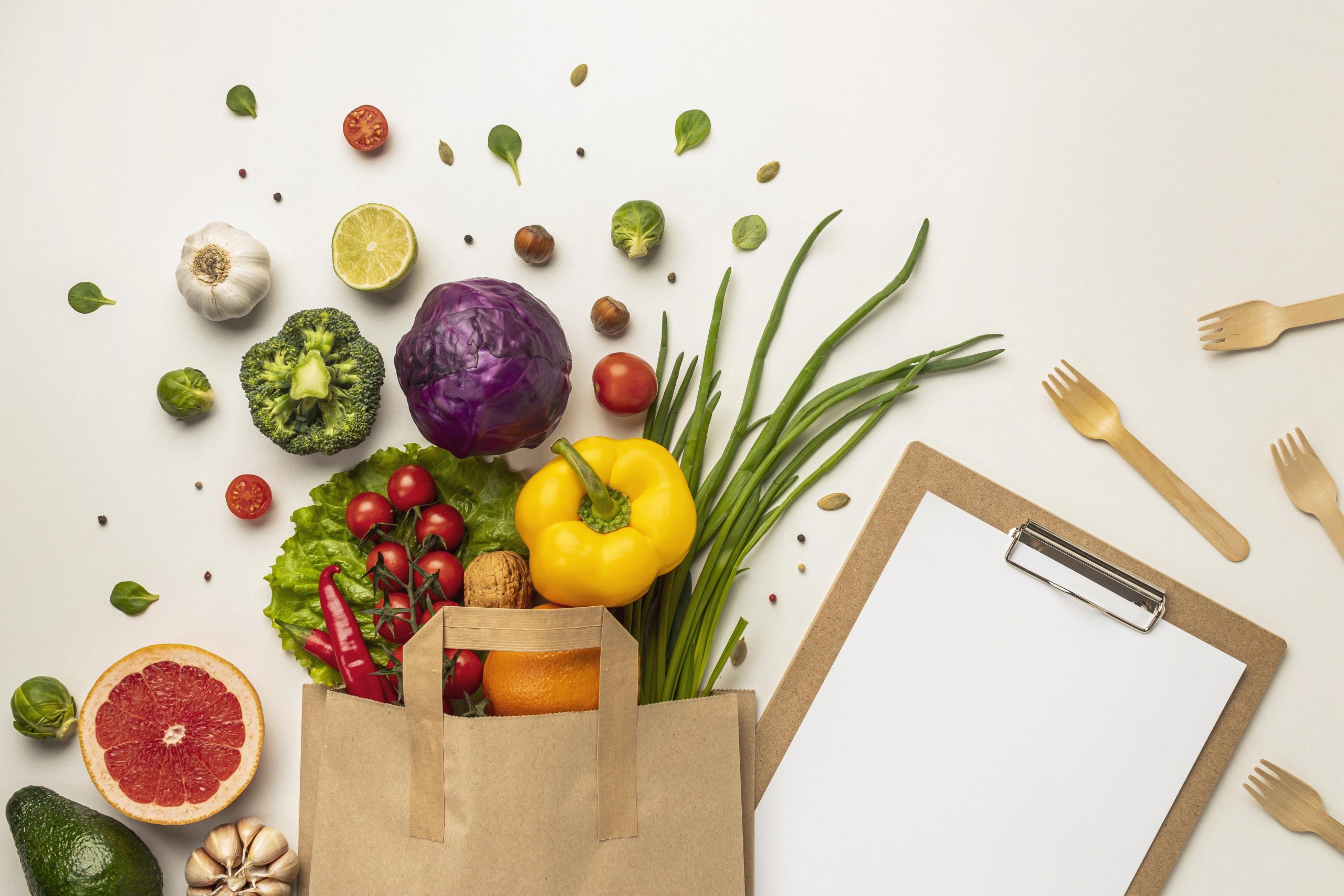 vegetables spilling out of paper bag with clipboard