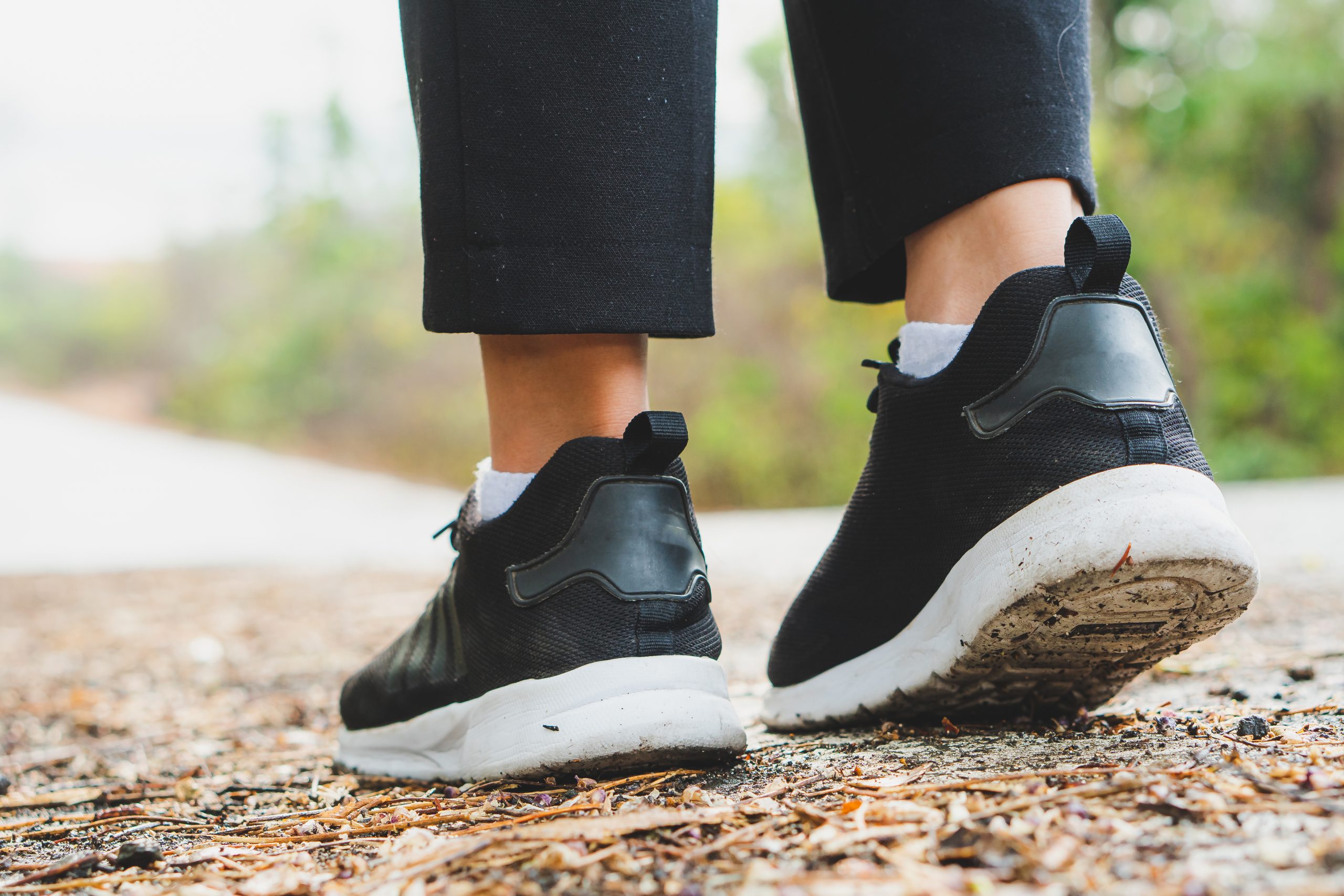 "close up black running shoes woman walking"